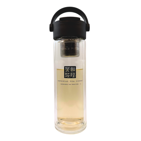 Clear glass tea infuser bottle with black lid on a white background