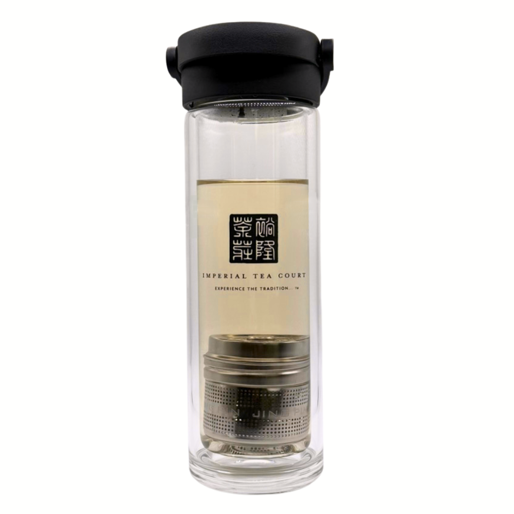 Clear glass tea infuser with black lid on a white background