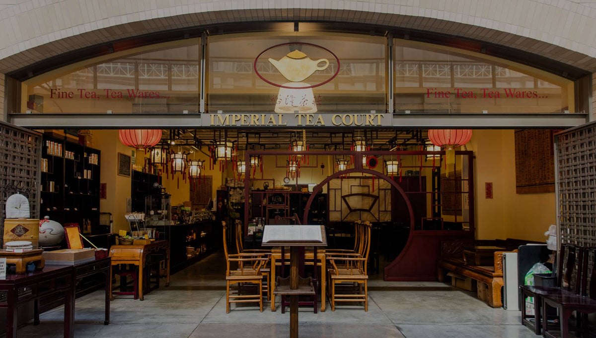 Imperial Tea Court storefront at the San Francisco Ferry Building, with red lanterns, wooden chairs and a round moon gate